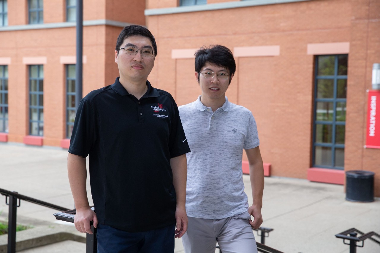 UC assistant professor Jingjie Wu, left, and UC doctoral student Tianyu Zhang are investigating new ways to convert carbon dioxide to fuel in Wu's chemical engineering lab