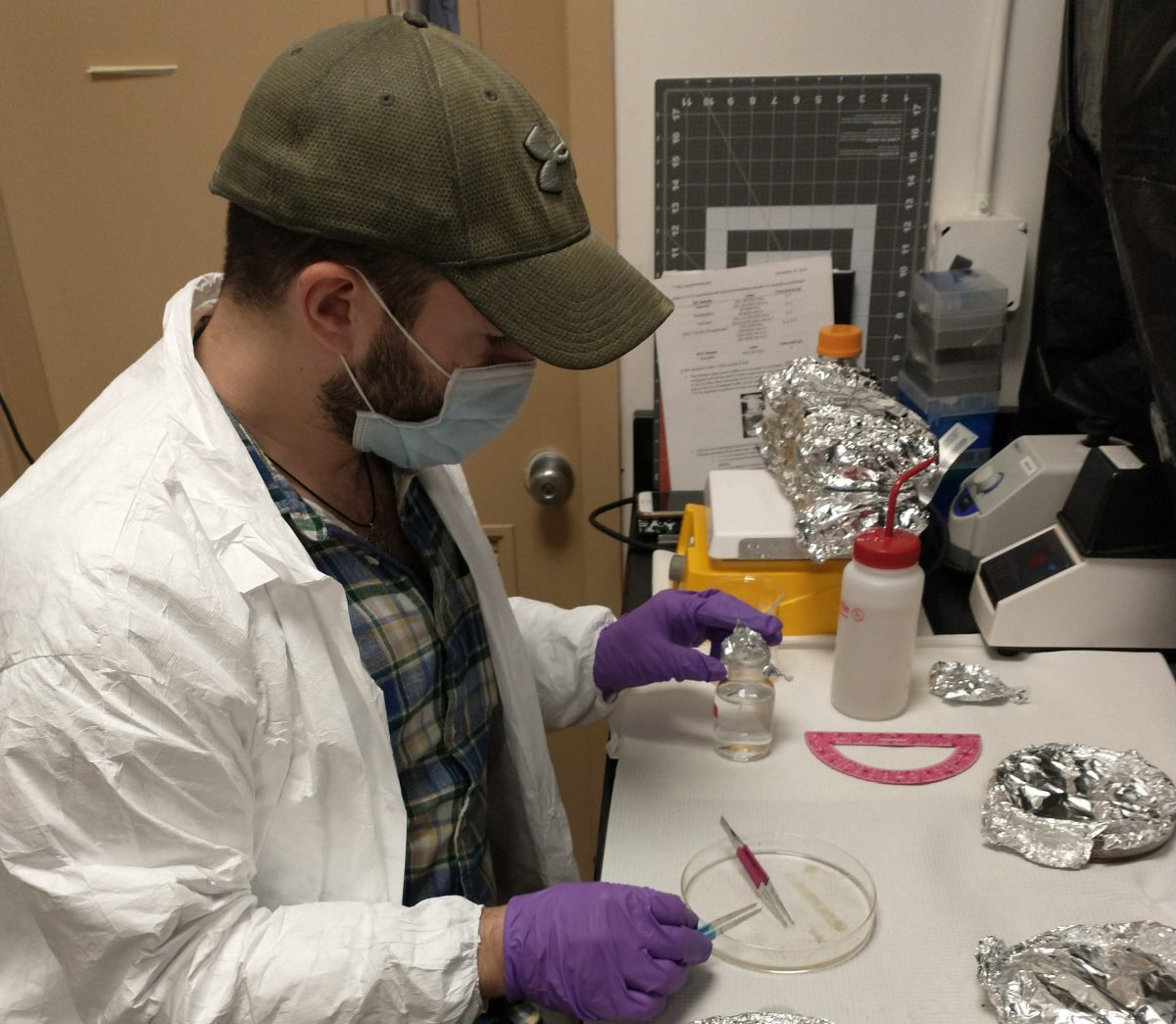 WHOI postdoctoral investigator Michael Mazzotta cuts plastic samples to measure respiration signals of microbial communities respiring cellulose diacetate. A new study led by WHOI researchers finds that cellulose diacetate, a bio-based plastic, degrades in the ocean faster than previously thought.