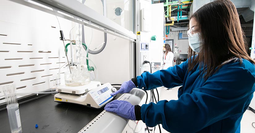 A researcher working with lab equipment. A Bio-Based Solution—An NREL researcher synthesizes a plant-derived epoxy that can be fully depolymerized at room temperature with a special catalyst.