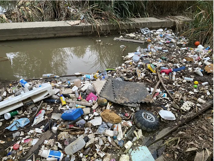 Recent rain storms washed plastic waste into a creek bed in Riverside's Fairmount Park