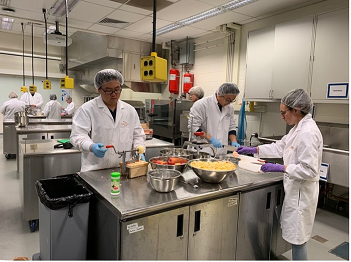 Students process produce in the Skidmore Lab located in the Nelson Hall of Food Science. 