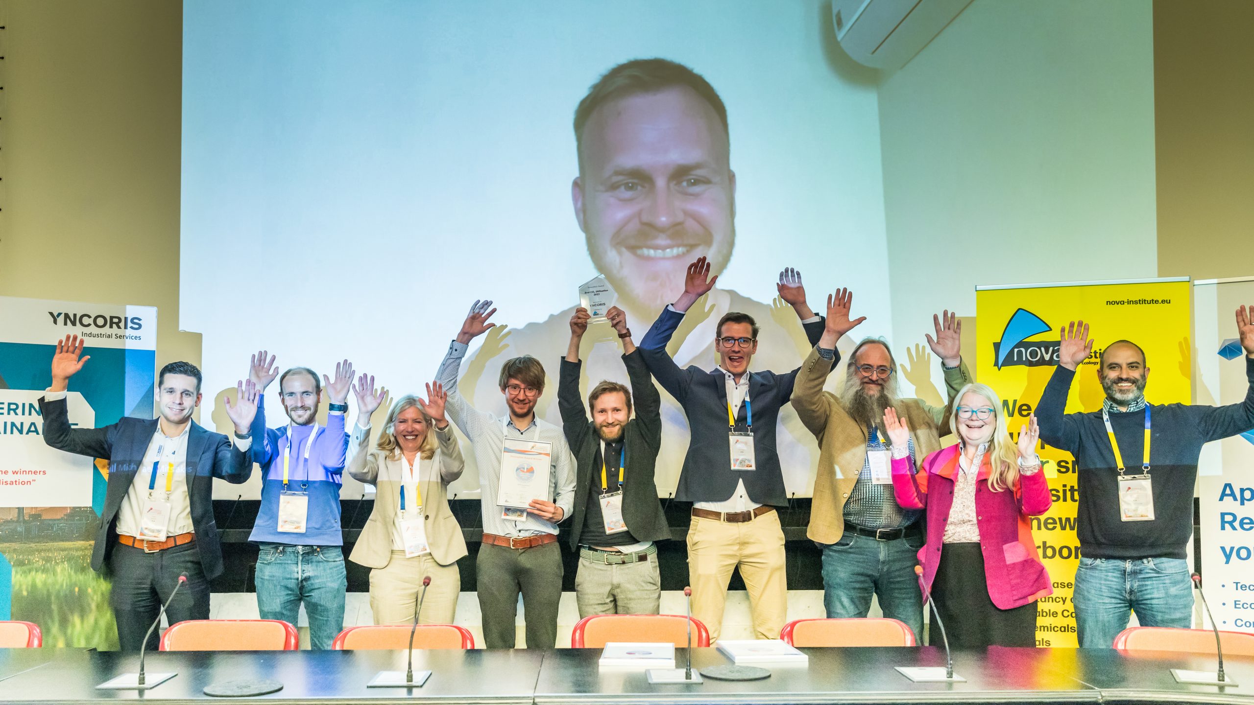 "Best CO₂ Utilisation 2023" innovation award nominees. From left to right Floris Buijzen (Borealis), Laurent Vandepaer (on), Babette Pettersen (Lanzatech), Martin Lindmeyer (Yncoris), Marc Philipp Vocht (DITF),   Thomas Mairegger (Rohrdorfer), Michael Carus (nova-Institut), Asta Partanen (nova-Institut), Anastasios Perimenis (CO₂ Value Europe), on screen Michael Mitsiakos (Arkeon)