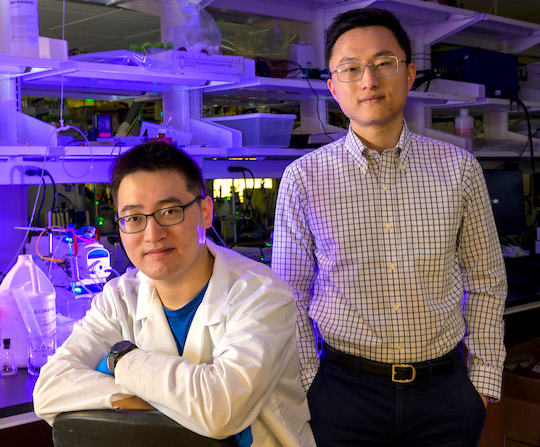 Peng Zhu (left) and Haotian Wang beside their carbon-capture device prototype