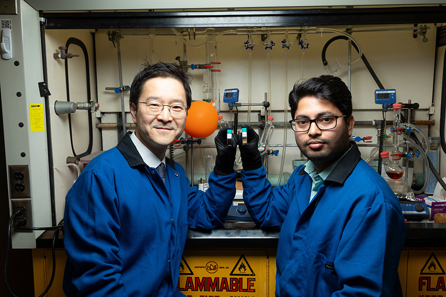 From left, Associate Professor Hoyong Chung and postdoctoral researcher Arijit Ghorai display the two phases of their degradable polymer at the Dittmer Chemistry Lab at Florida State University