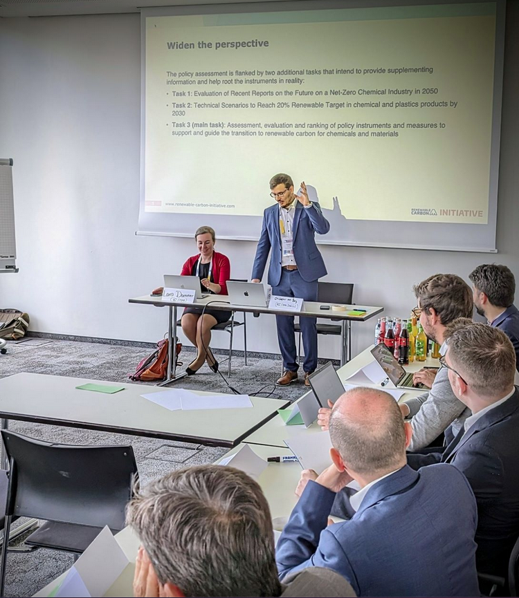 Christopher vom Berg holding his workshop about Presentation and Discussion of Instruments and Measures to help achieve relevant Levels of Renewable Carbon and Materials in the EU within relatively short period of time. Lara Dammer supporting him on the left 