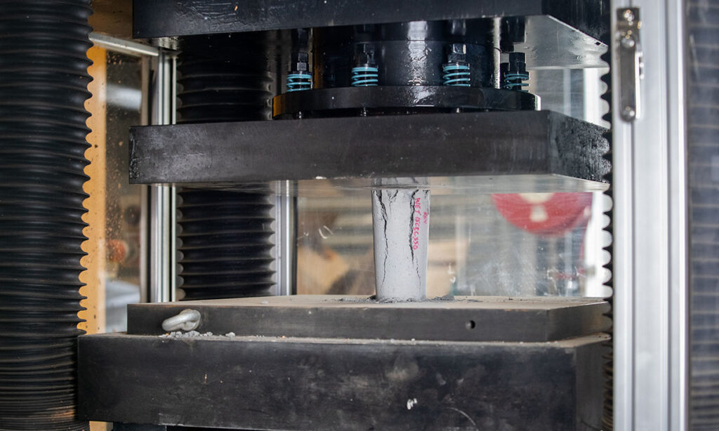 A concrete sample undergoing a strength test in the researcher’s lab at RMIT University.