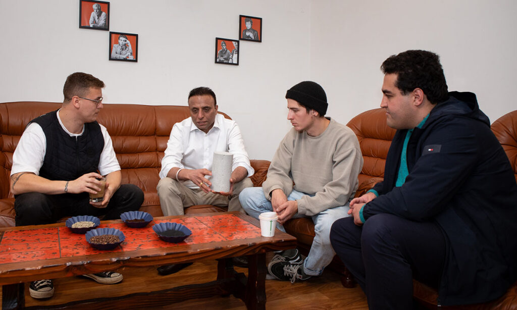 Drew Paten, Co-founder of Talwali, listens to Dr Rajeev Roychand explain how they used spent coffee grounds in their concrete, with fellow RMIT researchers Dr Shannon Kilmartin-Lynch and Dr Mohammad Saberian (pictured left to right).