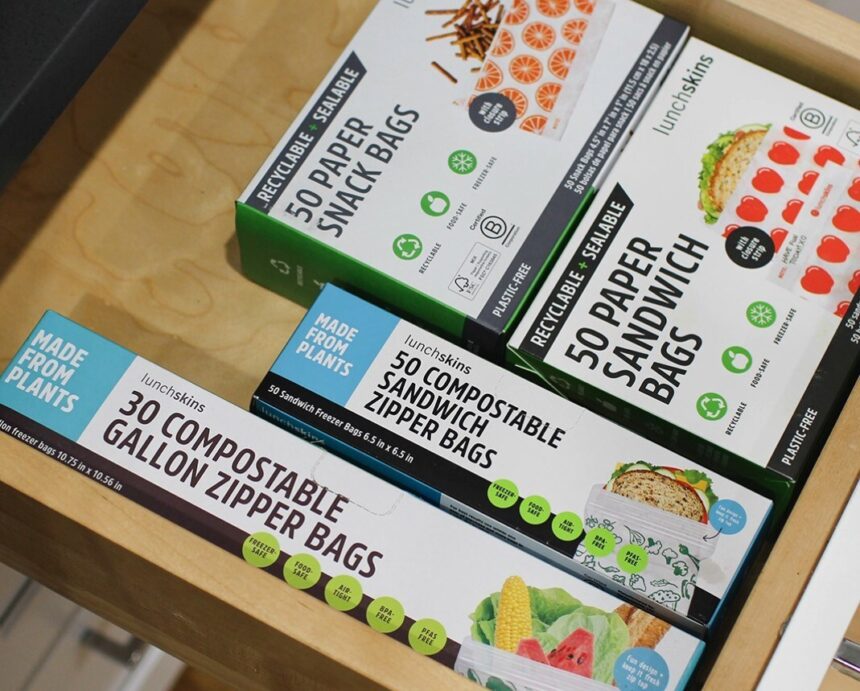 Lunchskins food storage bags neatly organized in a kitchen drawer, displayed in bold, eco-friendly, and colorful packaging