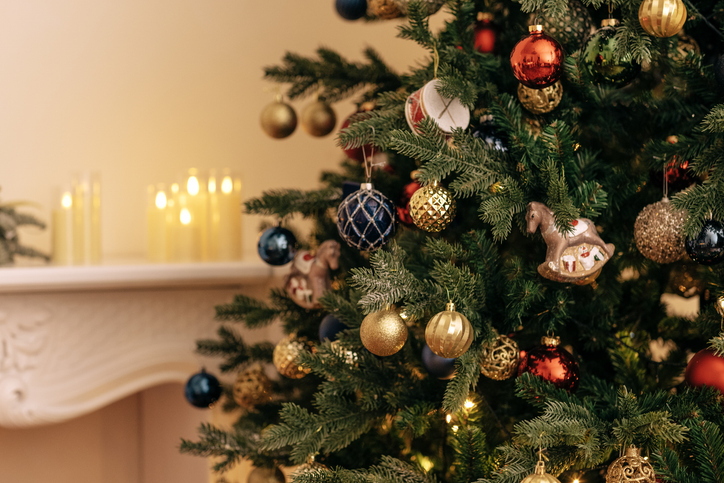 A close-up of a decorated Christmas tree with vintage glass toys.