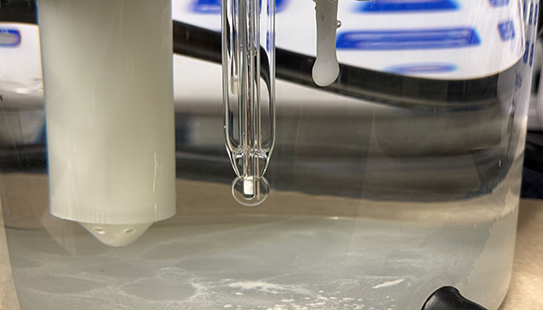 In the experimental setup, the carbon-negative material is forming around the tip of the electrode.