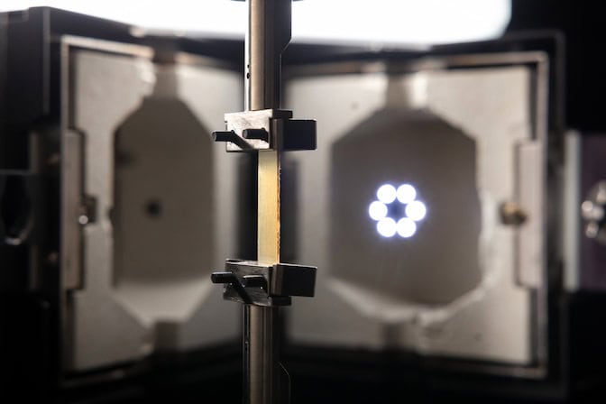 A piece of silk-derived plastic is secured in a metal clamp for strength testing. PHOTO: Thomas Angus, Imperial College London.