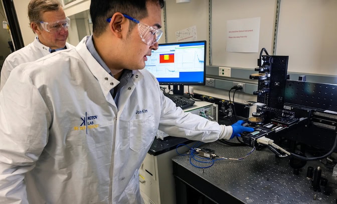 Nick Kotov, the Irving Langmuir Distinguished University Professor of Chemical Sciences and Engineering at U-M (left), and John Kim, a U-M postdoctoral research fellow in chemical engineering (right), measure how a silk-derived material polarizes and absorbs light. PHOTO: Marcin Szczepanski, University of Michigan Engineering.