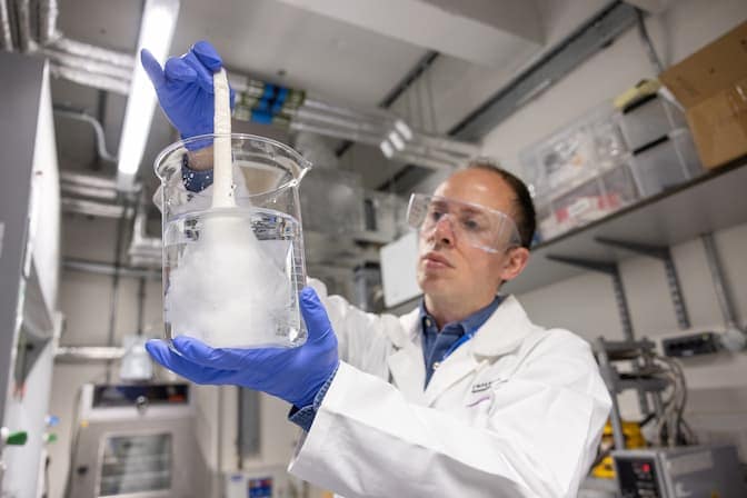 Emiliano Bilotti, an associate professor in multifunctional and sustainable polymer composites at Imperial College London, washes silk threads to prepare them for the hot press. PHOTO: Thomas Angus, Imperial College London.