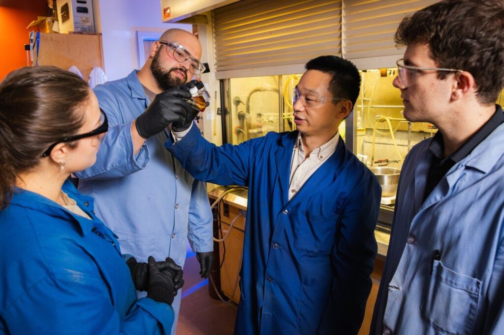 Researchers in the Liu Lab examine samples of engine oil created from upcycled plastic waste.