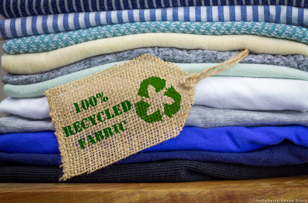 Recycle clothes icon on fabric label with 100% Recycled text, co